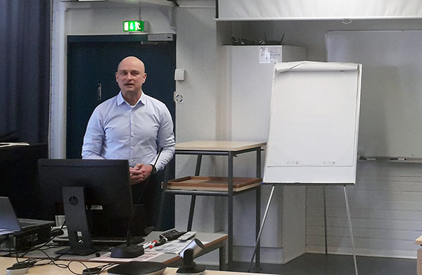 Mies luennoi luentotilassa.