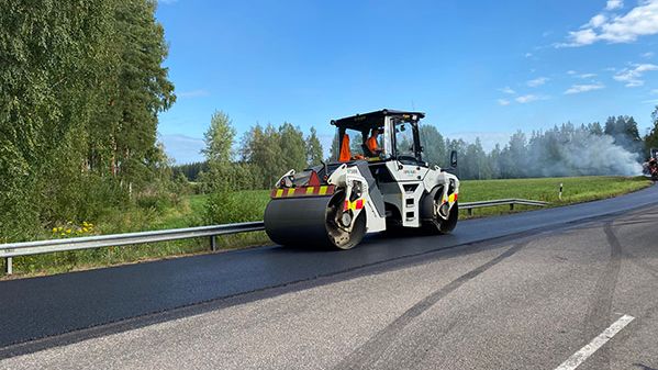 Tienpäällystystyökone tuoretta asfaltin pintaa työstämässä. 