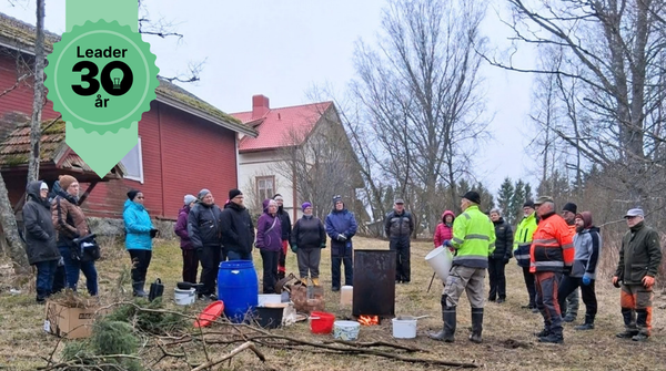 Ihmisiä kylätalon pihalla. 