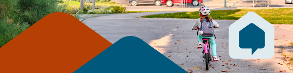 Koululainen pyöräilee asfaltilla.